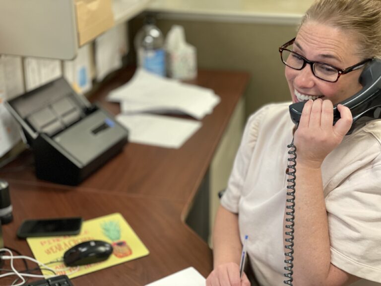 woman-on-telephone-in-busy-office-laughing-smili-2022-06-10-21-48-25-utc